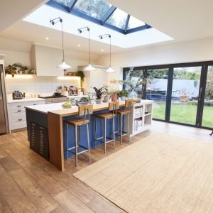 Interior View Of Beautiful Kitchen With Island Counter And Table For Children In New Family House